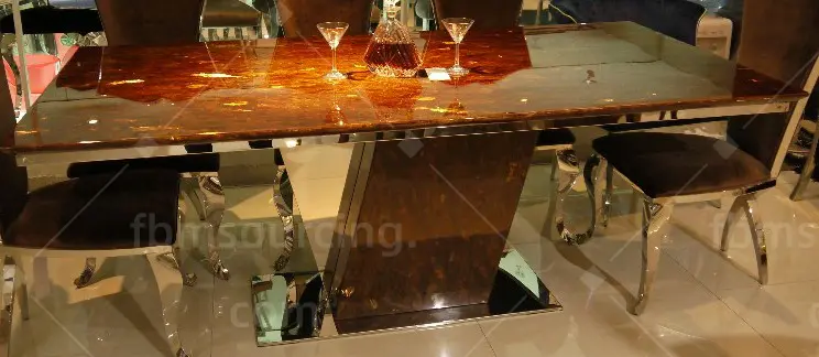 Gold dining table and chairs at Guangzhou luxury furniture showroom — FBM Sourcing Dubai