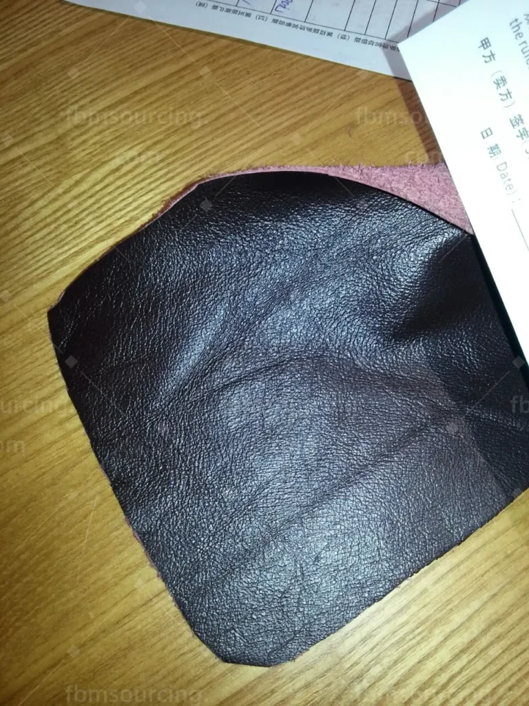 Dark leather upholstery texture check during quality inspection — FBM Sourcing