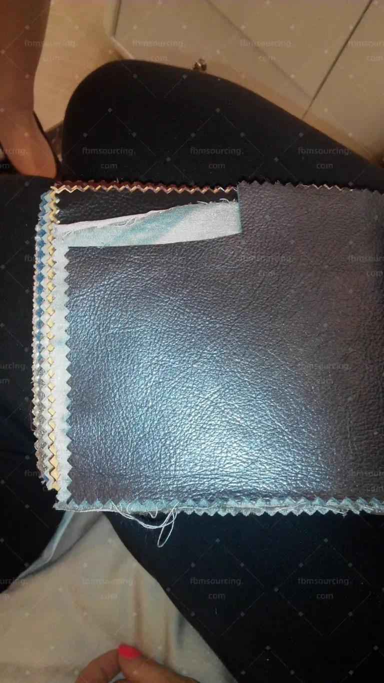 Dark leather sofa upholstery close-up quality check — FBM Sourcing Dubai
