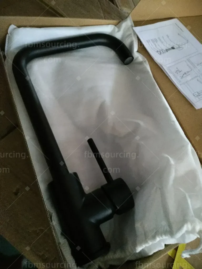 Matte black kitchen mixer tap unboxed for quality inspection