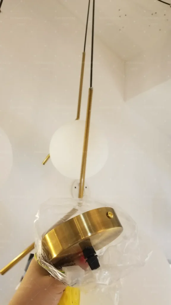 Brass and opal glass pendant light inspected at China factory