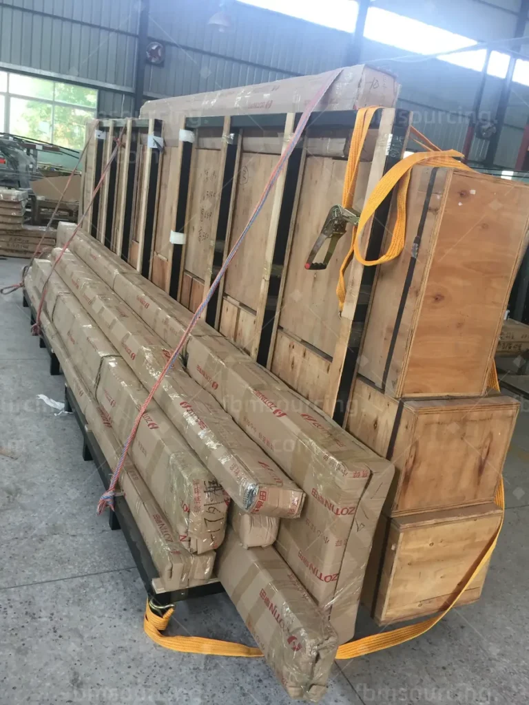 Long-length frames secured with straps on a steel loading rack