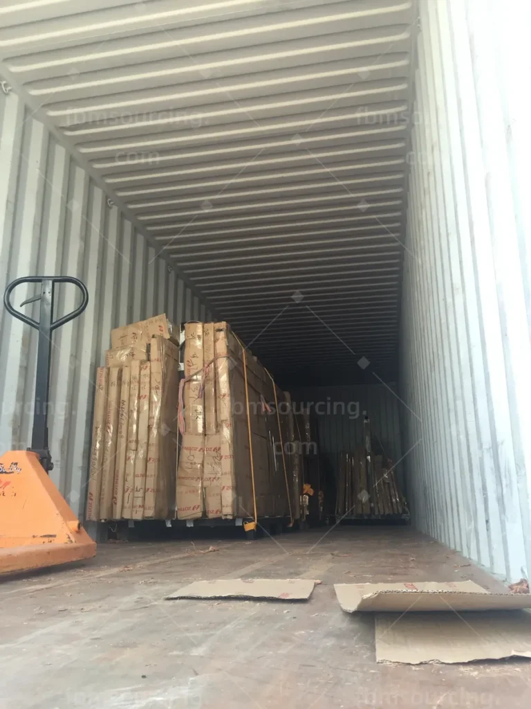 First pallets positioned inside the 40HQ container with a pallet jack