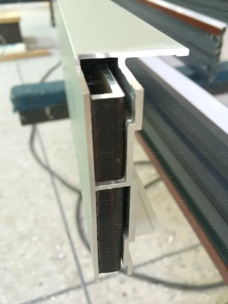 Thermal-break aluminium profile section examined during factory quality control