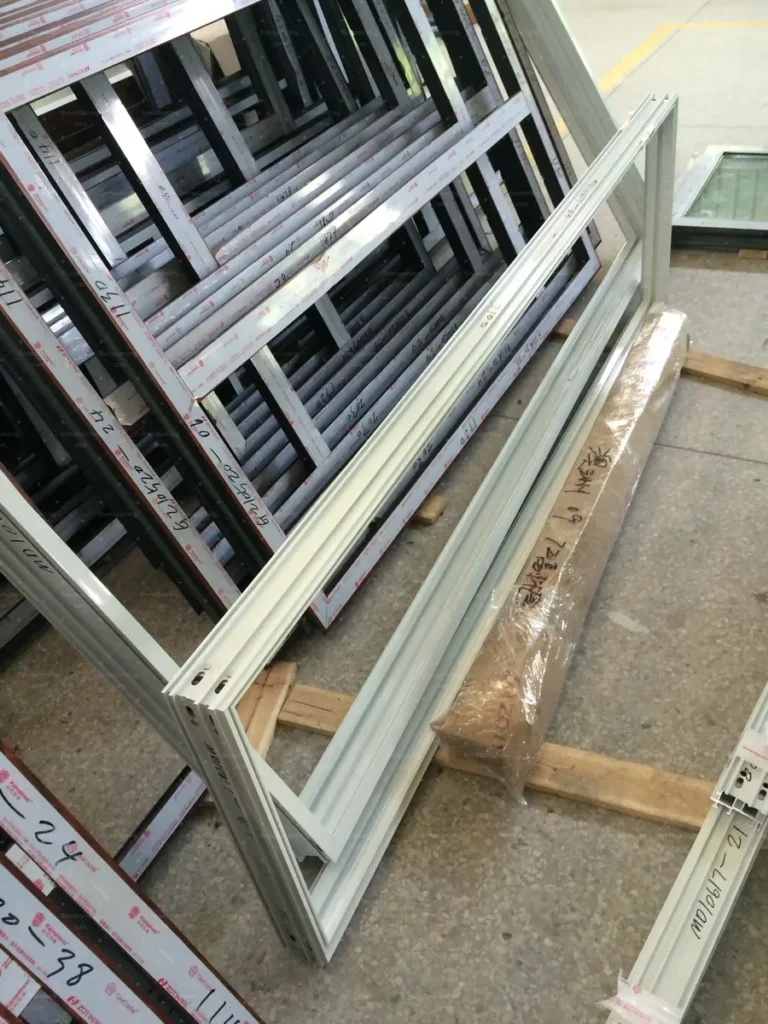 Fabricated window sub-frames stacked for inspection at the Chinese factory