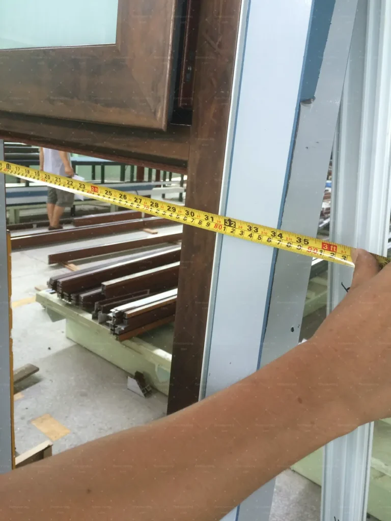 Frame width measured against the approved shop drawings during inspection