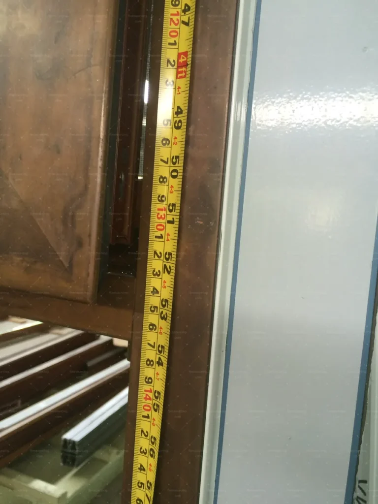 Sash height verified with a tape measure during pre-shipment quality control