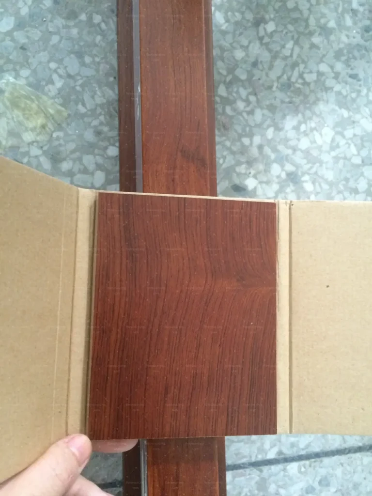 Approved timber-grain finish sample compared against production profiles