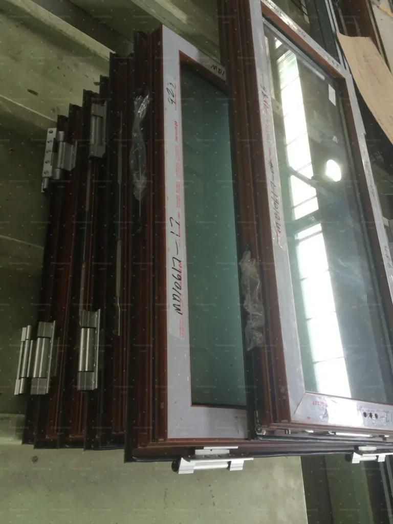 Hinged window sashes stacked with protective film after final quality checks