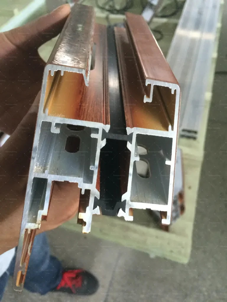 Wood-grain aluminium profile cross-section reviewed during the factory visit