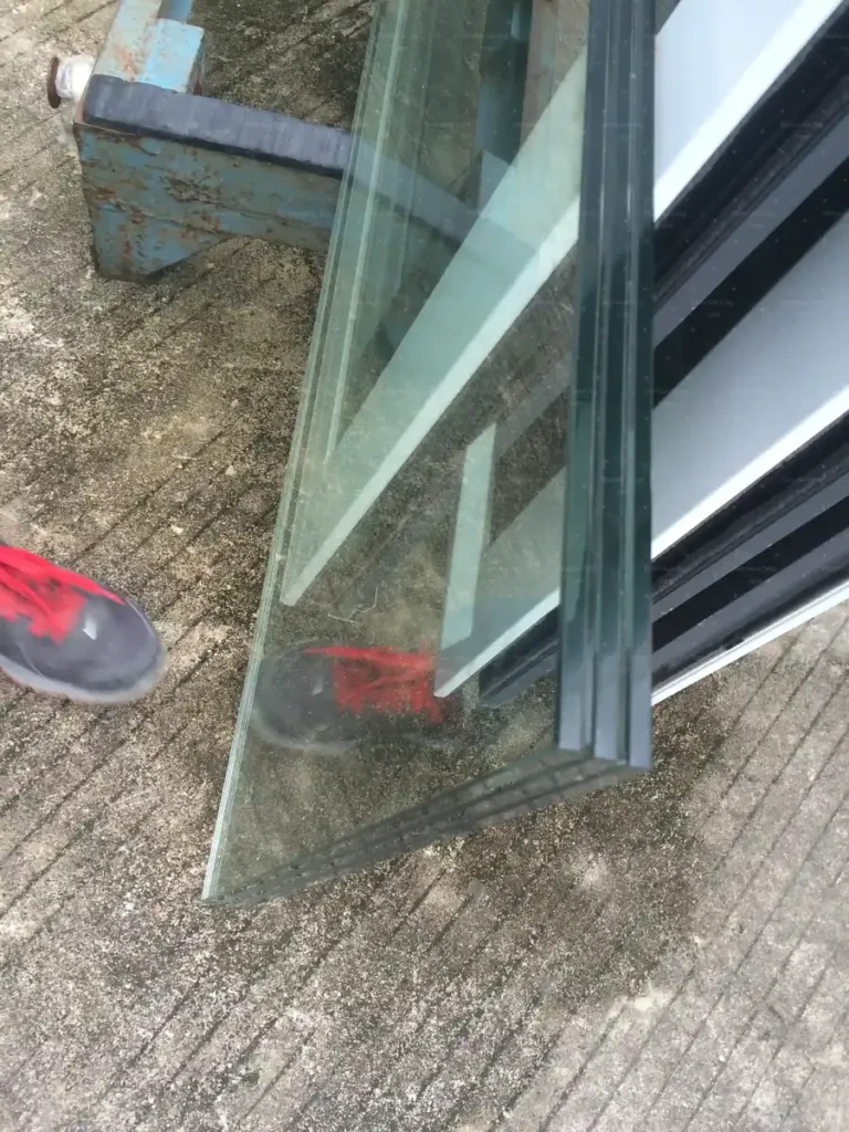 Double-glazed insulated glass unit edge inspected before sash assembly