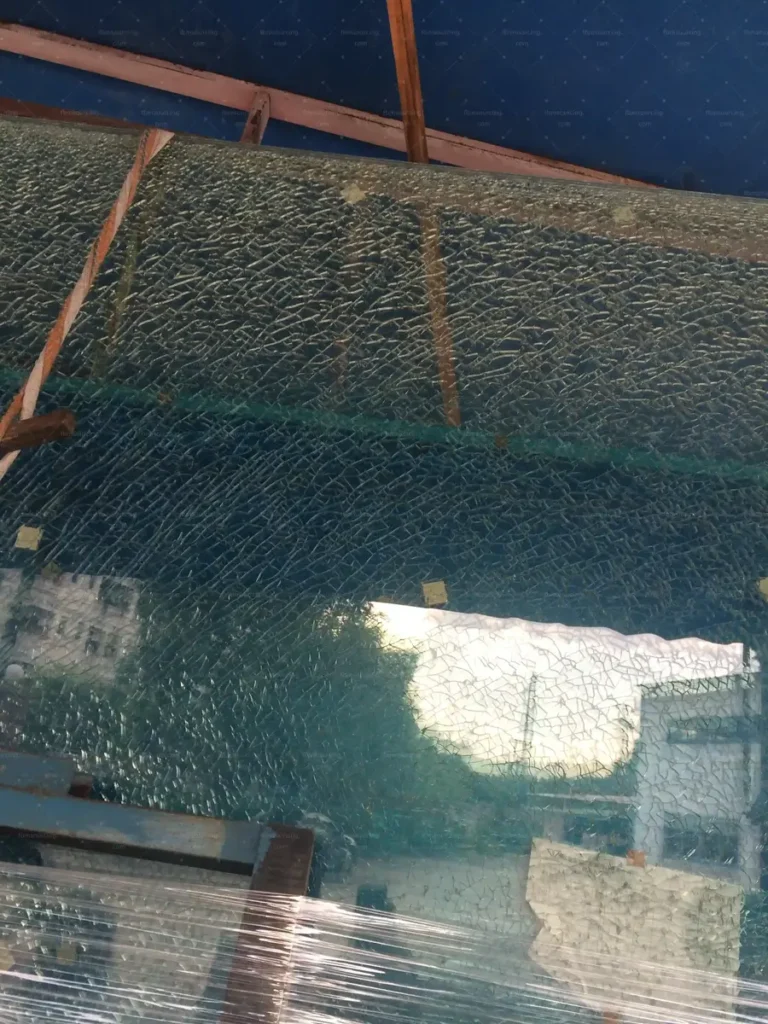 Damaged glass panel identified during inspection and rejected for replacement