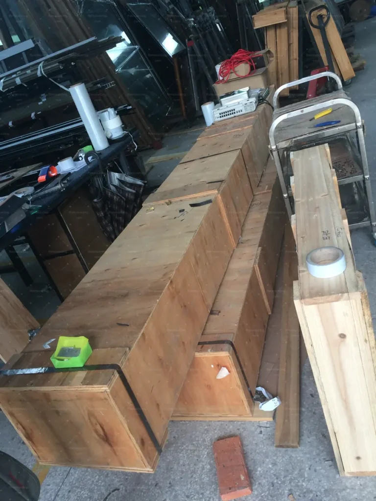 Long window frames packed in plywood crates ready for container shipping