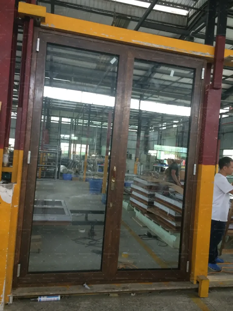 Completed timber-look aluminium sliding door standing for operation testing