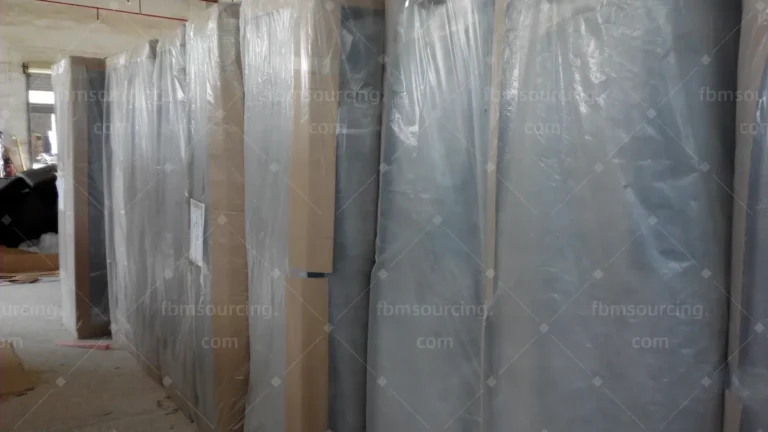 Netherlands sofa and office chair procurement - wrapped sofas staged in warehouse before container loading