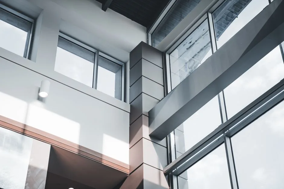 A modern architectural interior focusing on minimalist design and large windows.