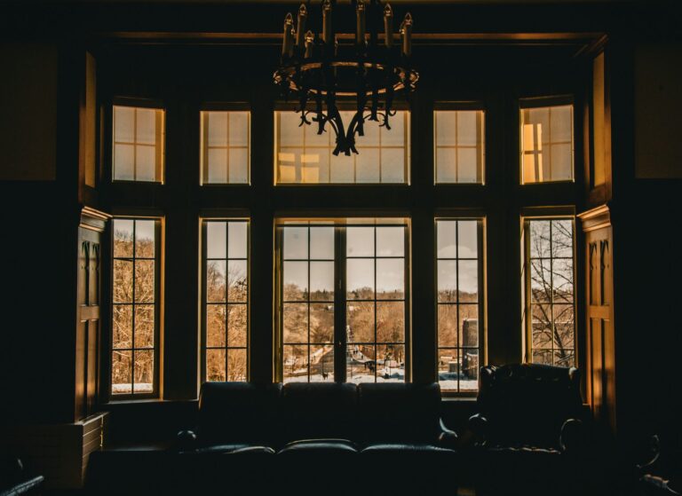 Warm interior with large windows overlooking a scenic outdoor view.
