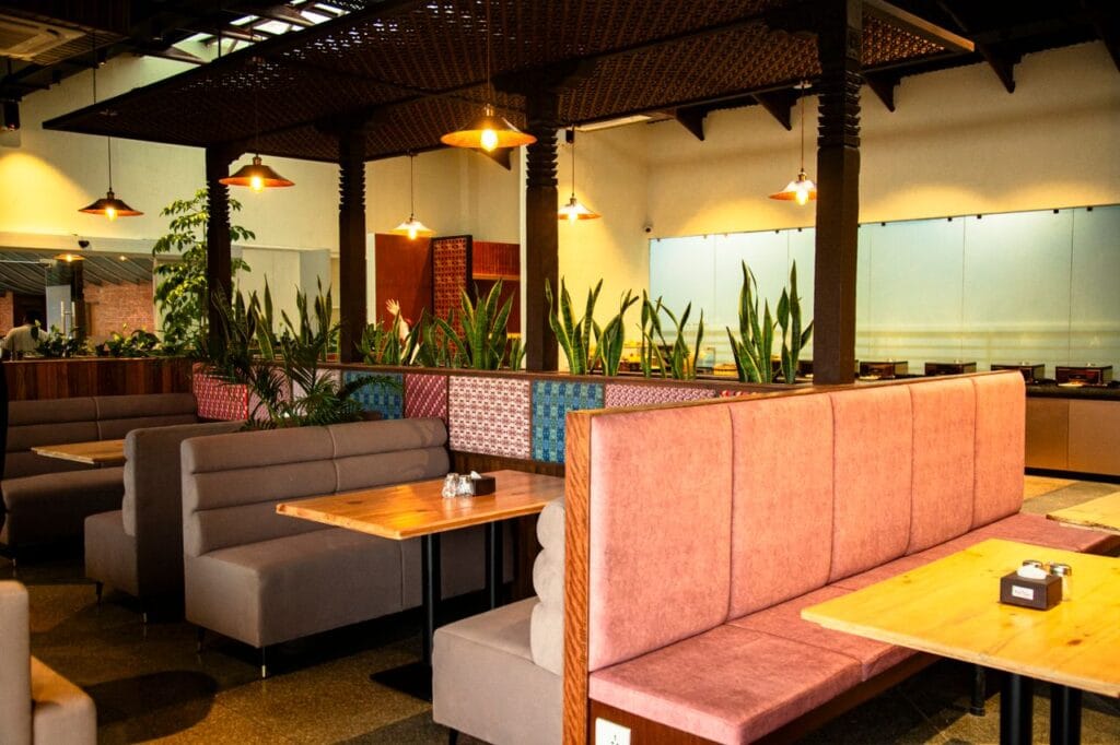 Warm, inviting restaurant interior showing empty booths and vibrant decor.