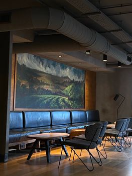 Stylish cafe in Valencia featuring modern seating and scenic wall art for a unique ambiance.