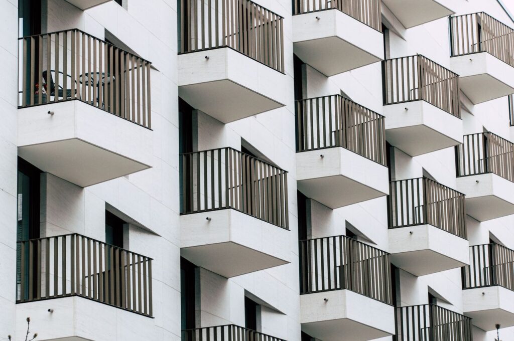 Urban apartment building with geometric balconies in modern architectural style.