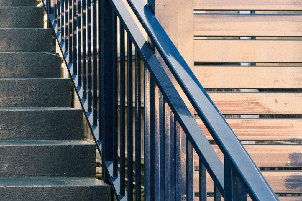 Elegant staircase design featuring modern railings and wooden paneling details.