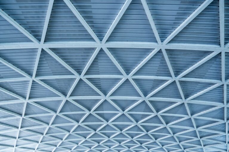 From below textured background of symmetrical ceiling of contemporary style house with shiny surface