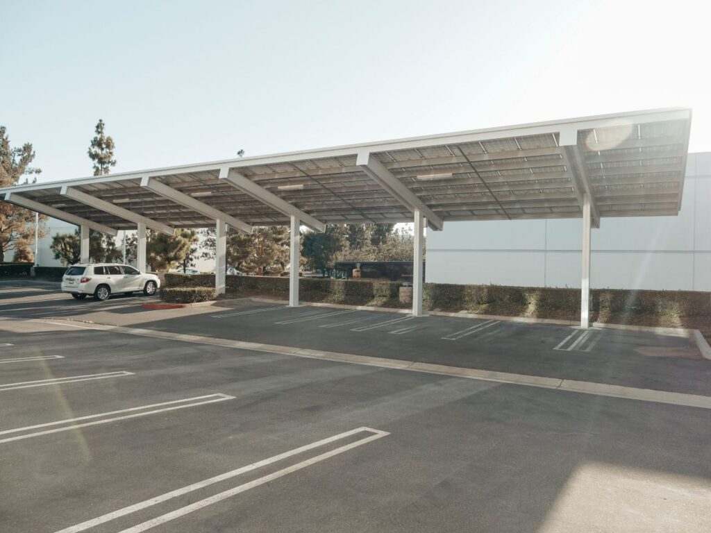 Solar panels installed over a parking lot, showcasing clean energy innovation outdoors.