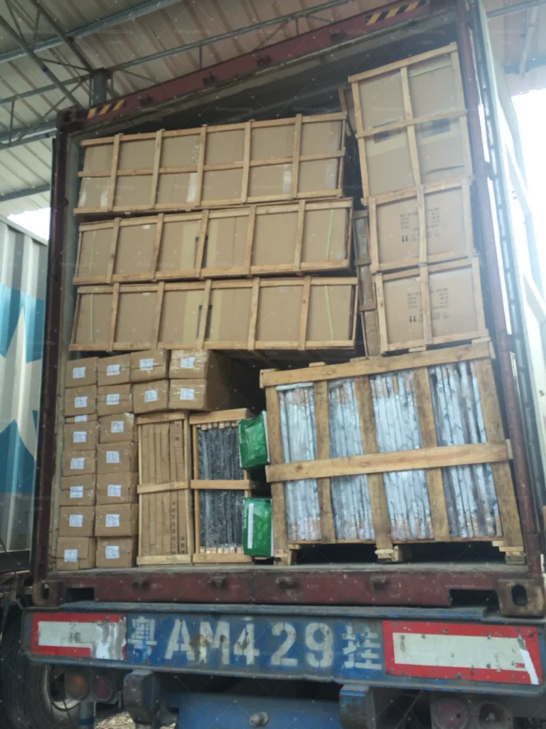 Third container loaded with villa furniture cartons and wooden crates