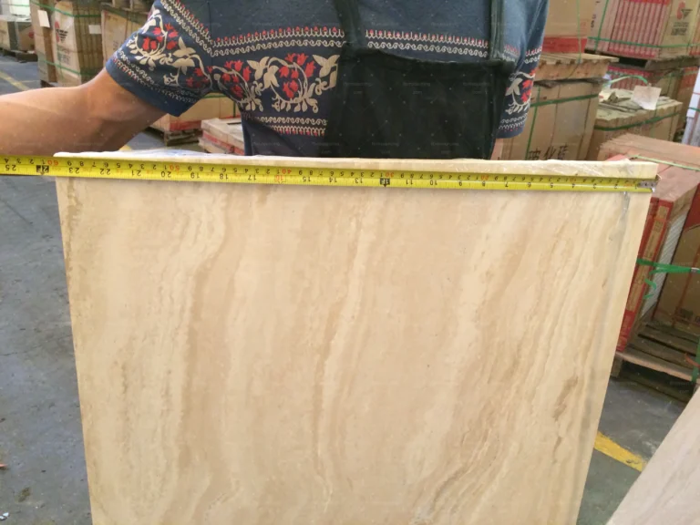 Inspector measuring wooden board dimensions during villa furniture quality control in China