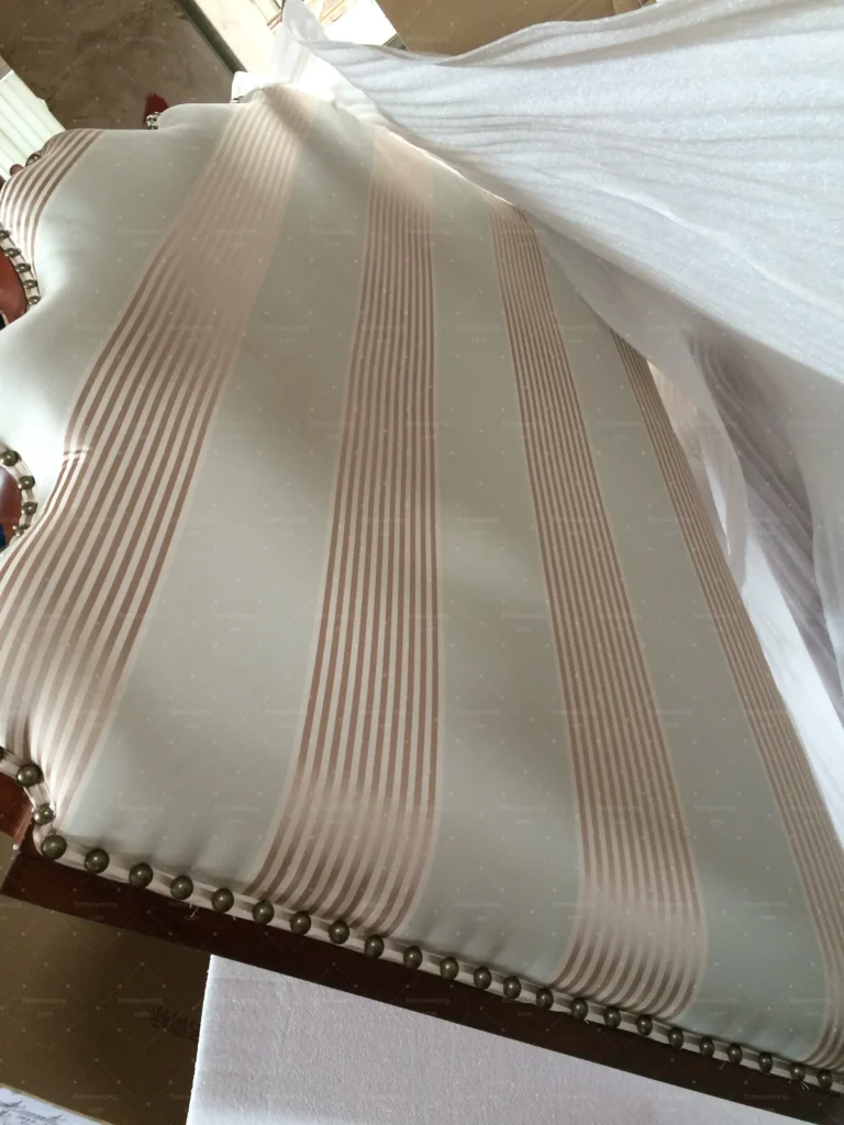 Striped upholstery fabric and seam quality checked during sofa quality control