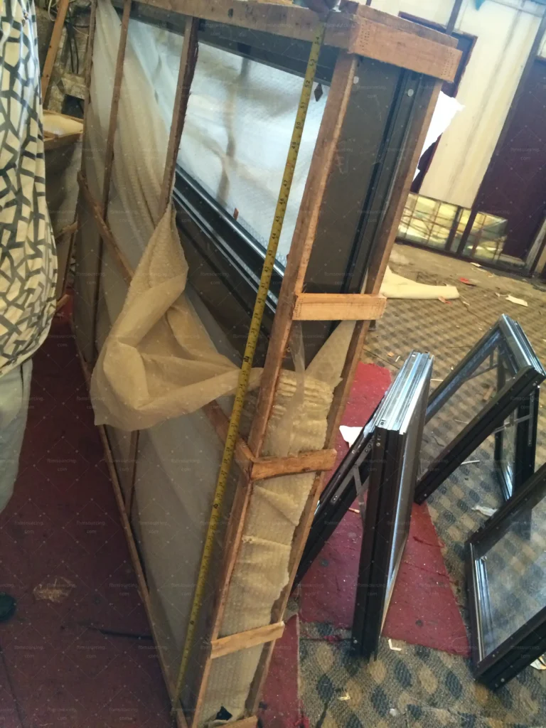 Crated glass shower door checked before container loading