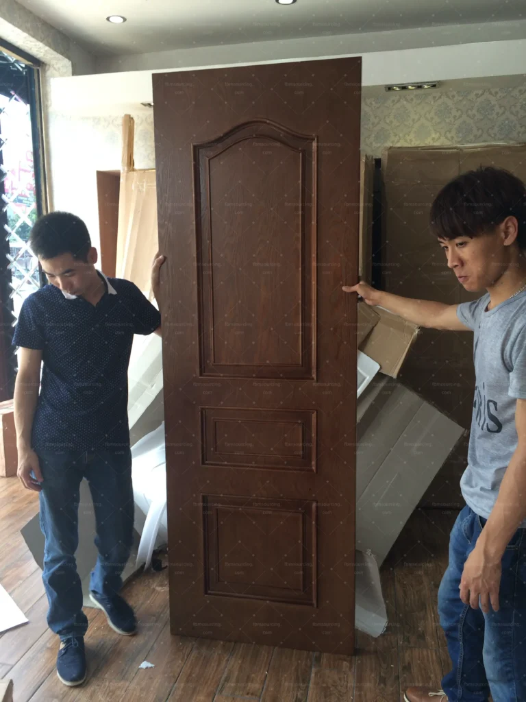 Finished wooden door carried for final inspection at the factory