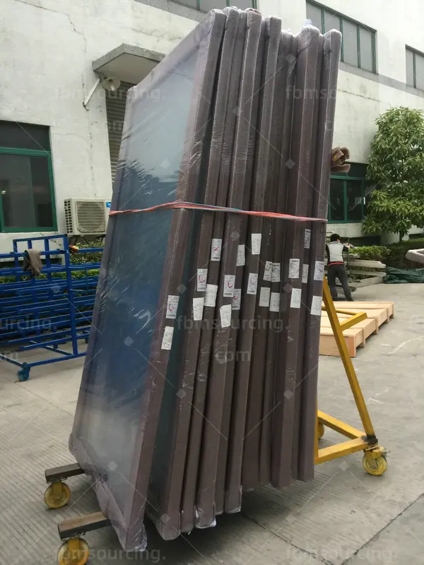 building material sourcing agent container loading - glass door panels staged for container - US contractor project