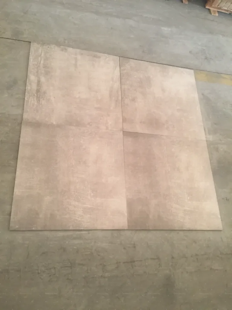 Floor tiles laid out for shade matching during China tile factory inspection