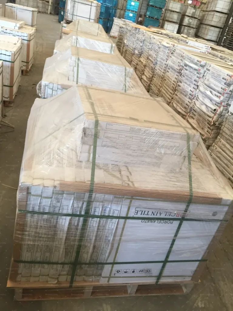 Packed tile pallets staged in China warehouse before container loading