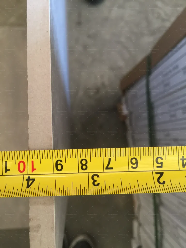 Tile thickness measured with tape during quality control in Foshan