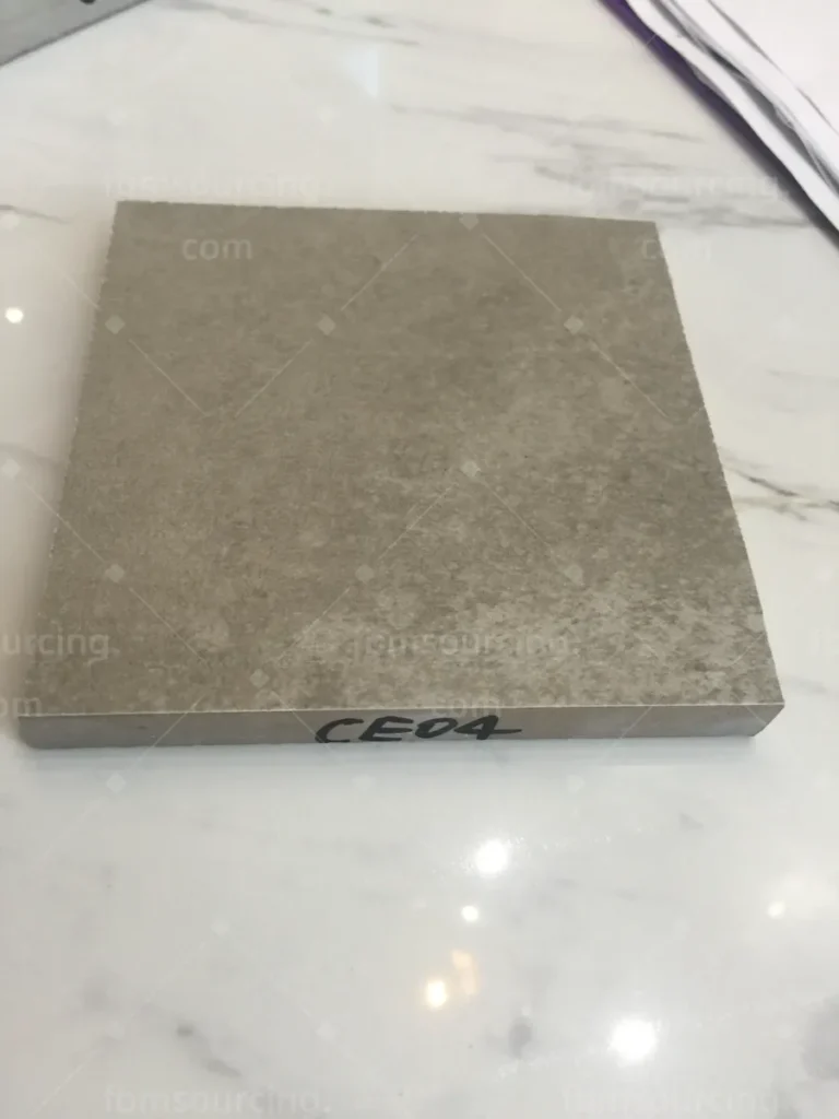 Grey porcelain floor tile sample selected with building material sourcing agent for Australian villa project