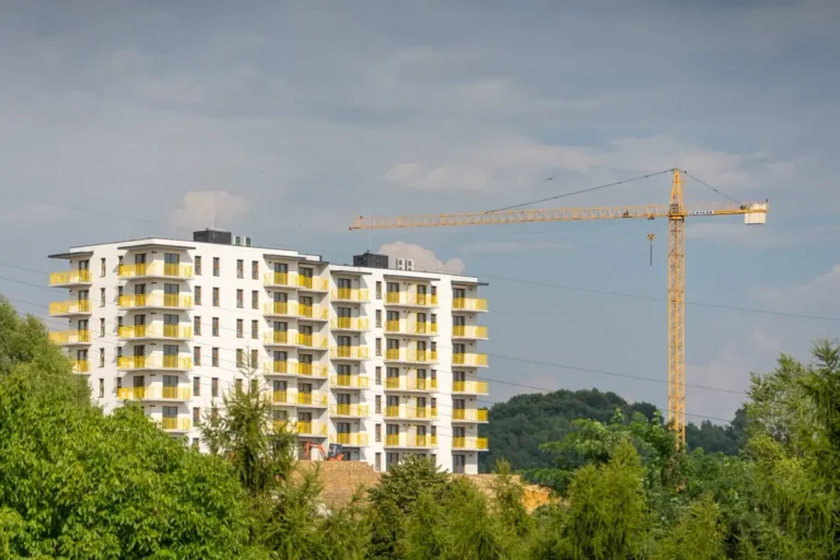 Apartment development under construction with tower crane, furniture and building materials procurement from China