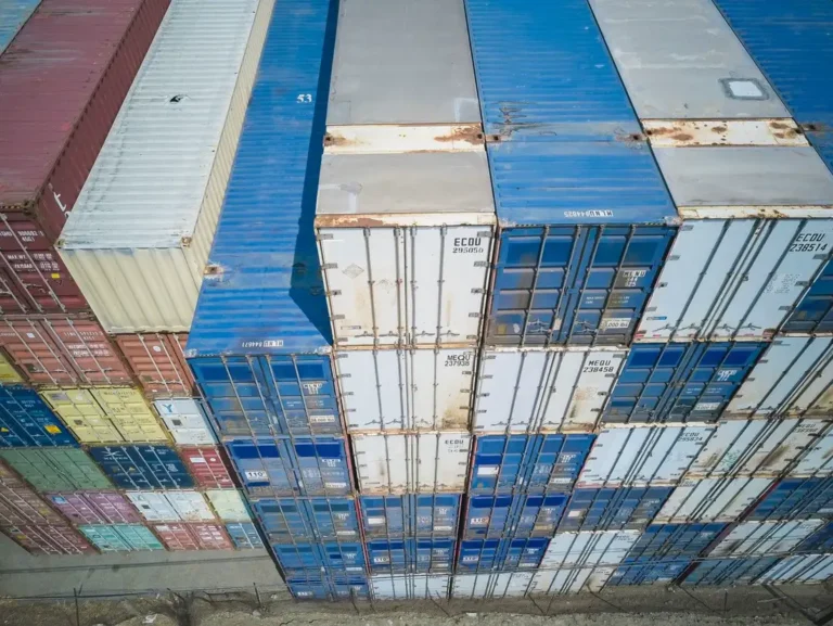 Stacked shipping containers at a consolidation yard for multi-factory China project cargo
