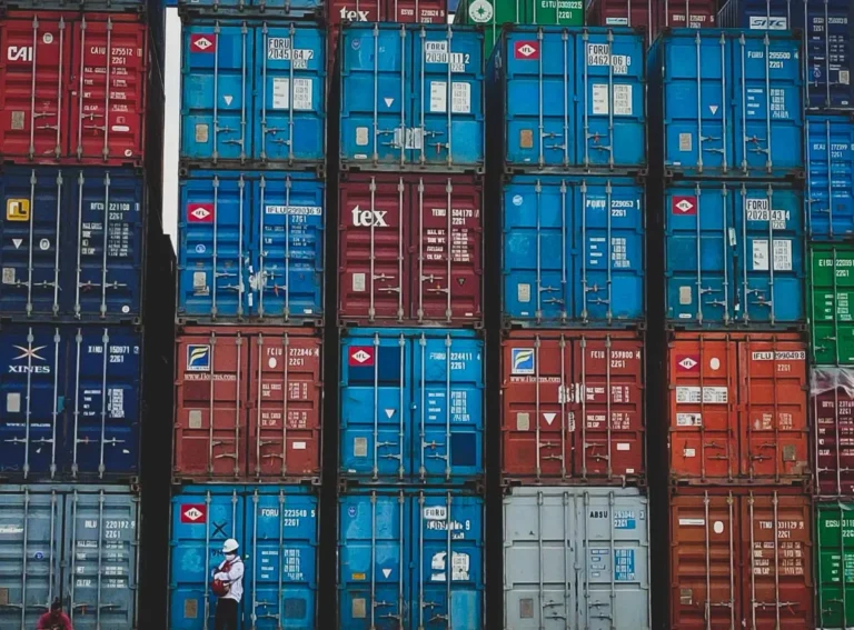 Stacked export shipping containers at a China port for commercial project procurement