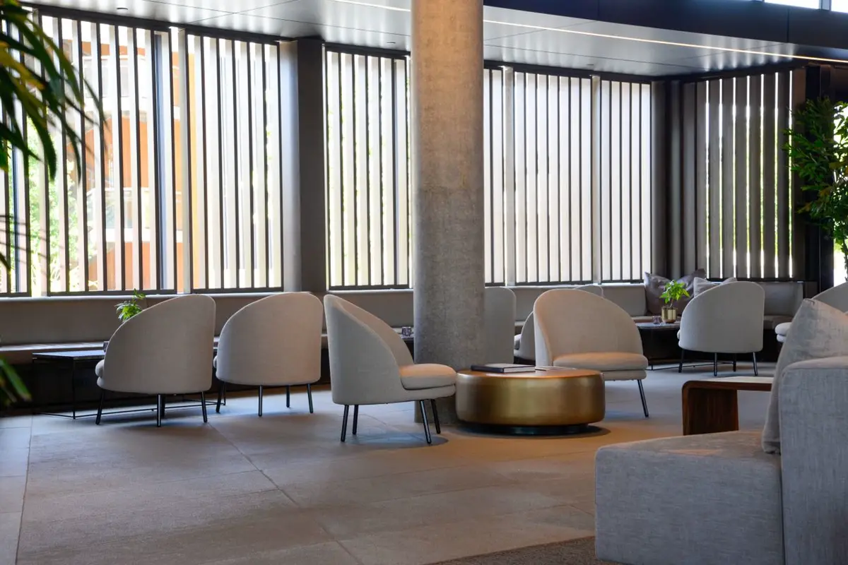 Hotel lounge with upholstered armchairs — fabric vs vinyl upholstery for commercial seating