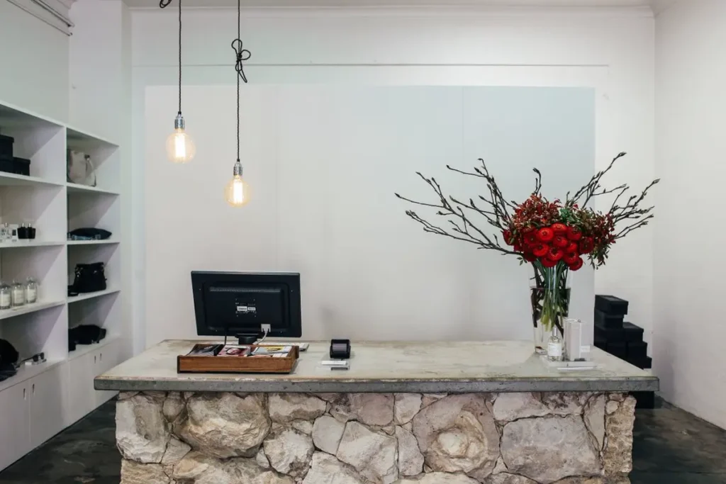 Stone-clad checkout millwork counter in a retail store fit-out