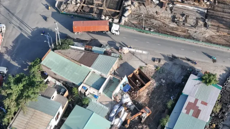 Container truck passing a construction site, illustrating door-to-site delivery for China project orders