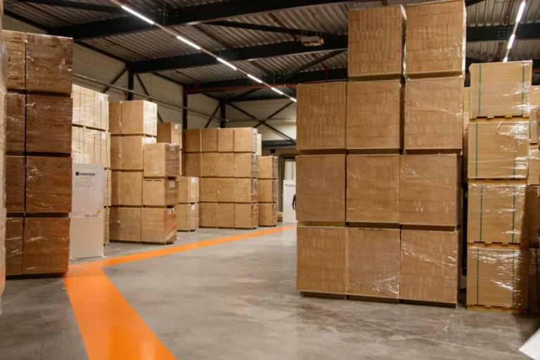 FF&E installation coordination warehouse with palletized furniture cartons awaiting hotel project delivery