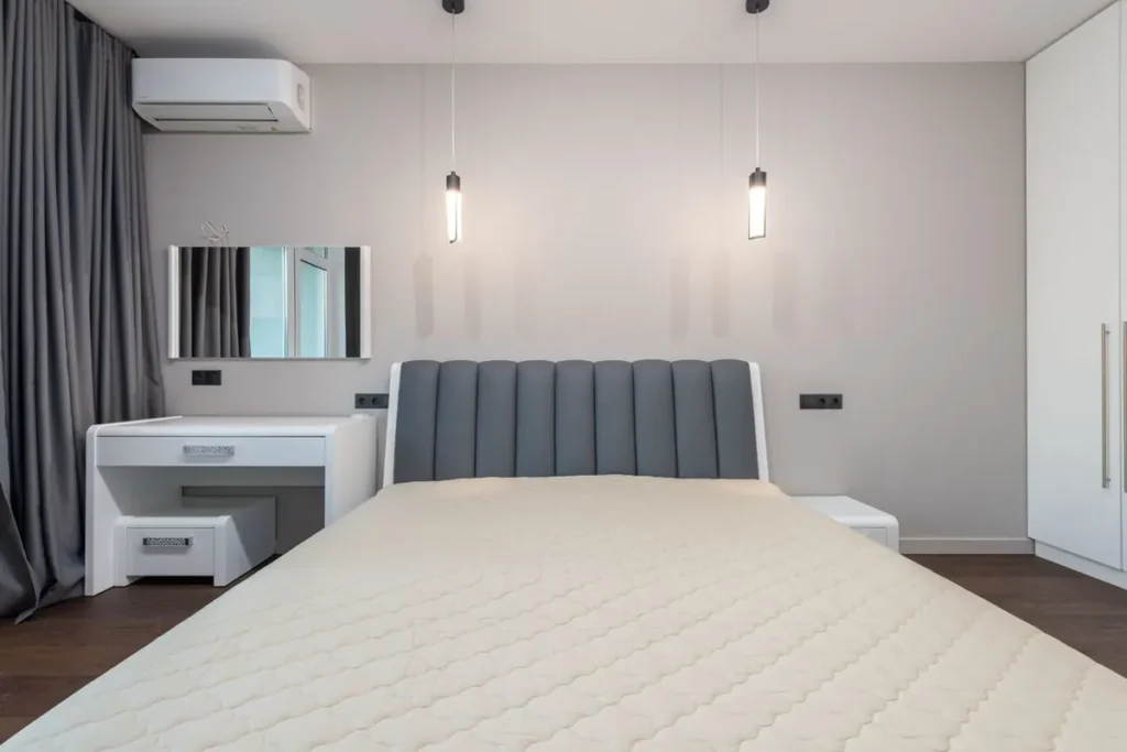 Hotel guest room with built-in wardrobe and loose bed — fixed vs loose FF&E scope on hotel projects