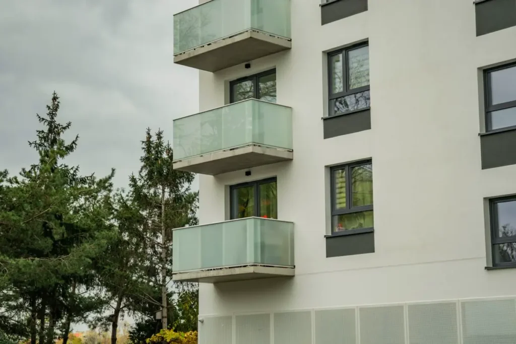 Glass balustrades on apartment balconies, compared with aluminum and cable balustrade systems for commercial buildings
