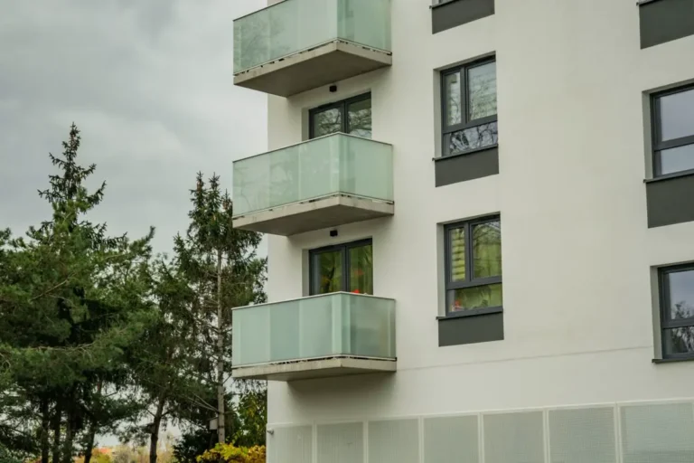 Glass balustrades on apartment balconies, compared with aluminum and cable balustrade systems for commercial buildings
