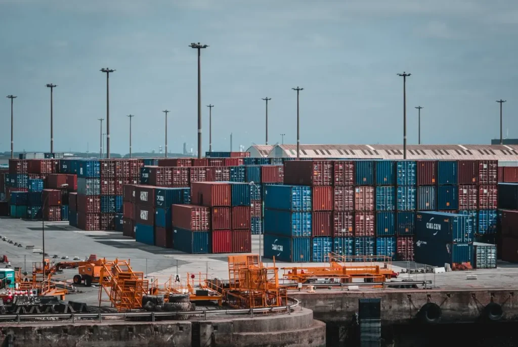 Container yard with handling equipment, illustrating HS codes for furniture and building materials imported from China