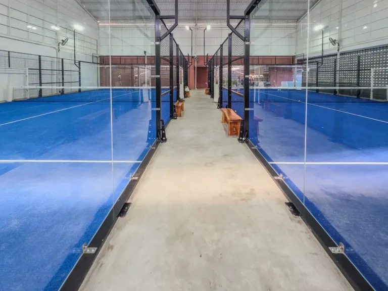 Indoor padel court with tempered glass walls for sports club FF&E procurement
