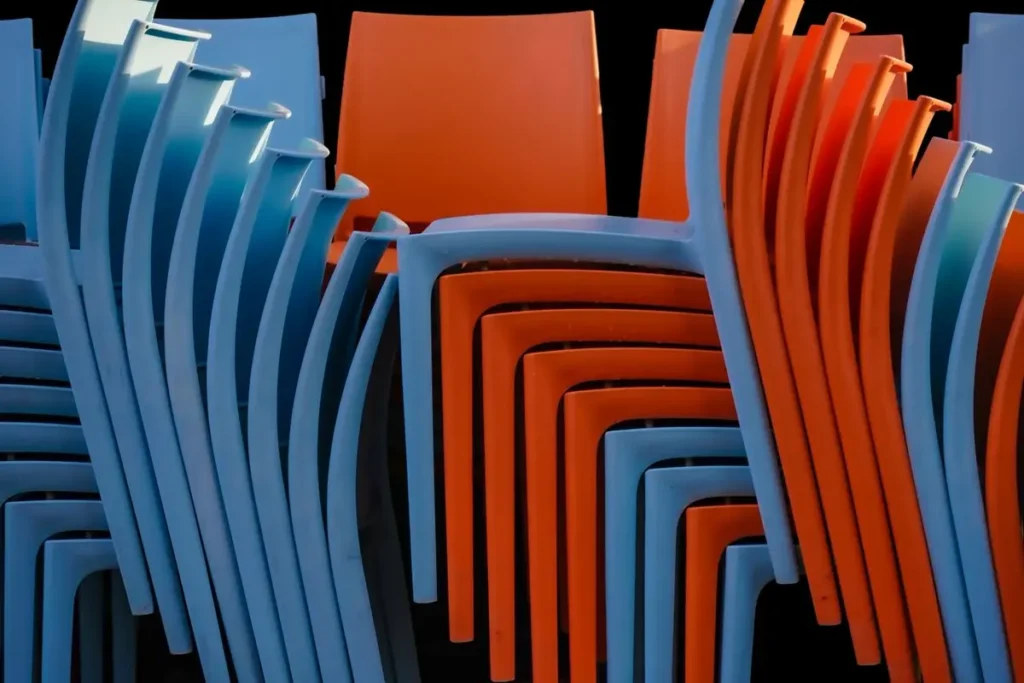 Stacked colorful plastic chairs - plastic chair sourcing from China